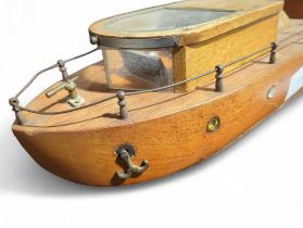 A 20th century scratch made teak model of a boat,