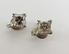 A pair of princess cut diamond stud earrings, in f