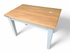 A light oak rectangular kitchen table, on an off w