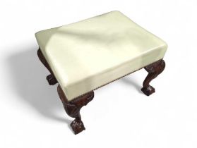 A varnished mahogany foot stool, on four ball and
