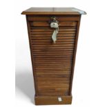 An early 20th century oak filing cabinet, with tam