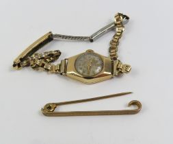 A lightly patterned 9ct gold bar brooch, 2g gross;