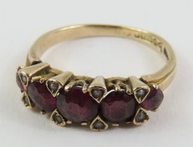 A 9ct gold garnet and simulated pearl ring, the pe