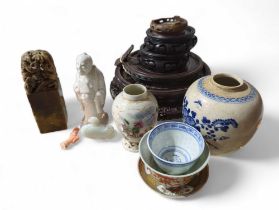 A white and blue ginger jar, decorated with flower