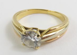 A diamond solitaire ring, the three colour gold ba