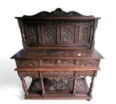 A Victorian stained oak sideboard, with heavily ca