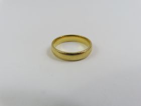 An 18ct gold wedding band, probably by Barker Brot