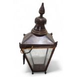 A copper outdoor lantern light fitting, with four