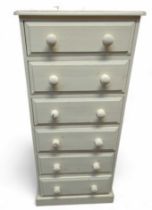 A tall cream painted chest of six short drawers, 1