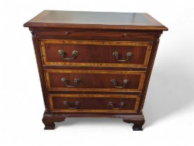 A reproduction chest of three drawers, with veneer