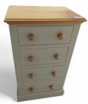 A light grey painted chest of four short drawers,