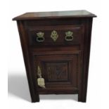A stained oak cabinet, the single drawer with bras