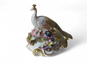 A Royal Crown Derby figure of a peacock perched on
