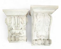 A white plaster wall sconce, with acanthus leaf an