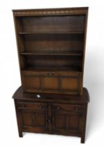 A dark Ercol dresser, the top with three shelves a