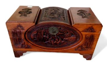 A 20th century carved camphorwood chest, with scen