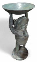 A patinated metal model of a frog or toad holding