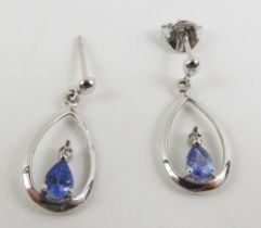 A pair of white gold drop earrings, set with a pea
