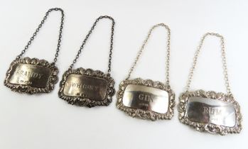 A pair of silver decanter labels 'whisky' and 'bra