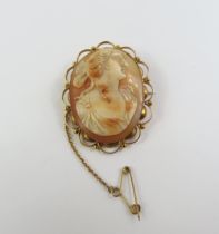 An orange and white shell cameo brooch, marked '9c