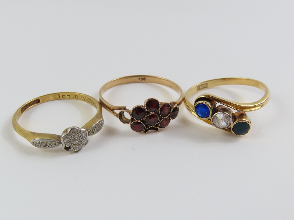 An early 20th century three stone twist ring, mark