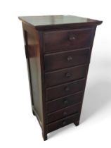 A tall darkwood chest of seven drawers, 101.5cms h