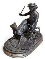 A spelter figure of a boy with a hoop and a dog, a