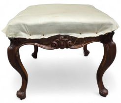 A rectangular upholstered stool with moulded decor