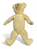 An early 20th Century teddy bear with golden plush