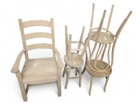 A modern heavy ladder back chair with arm rests an