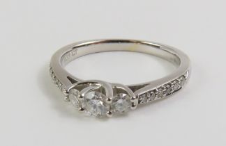 An 18ct white gold diamond three stone ring with d