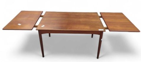 A mid century rectangular teak draw leaf dining table on four