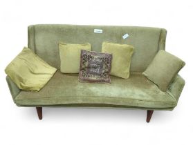 A mid century Scandinavian design green upholstered settee on shaped t