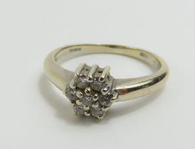 An 18ct white gold diamond cluster ring, marked '0