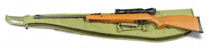 A Crossman Optimus air rifle with scope, target cards