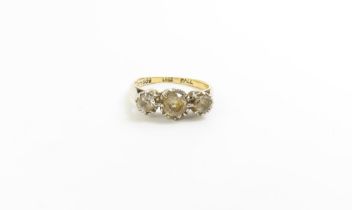 A three stone old cut diamond ring, marked '18ct', finger si