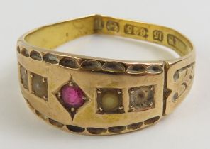 A 15ct gold ring set with a ruby, with patterned s