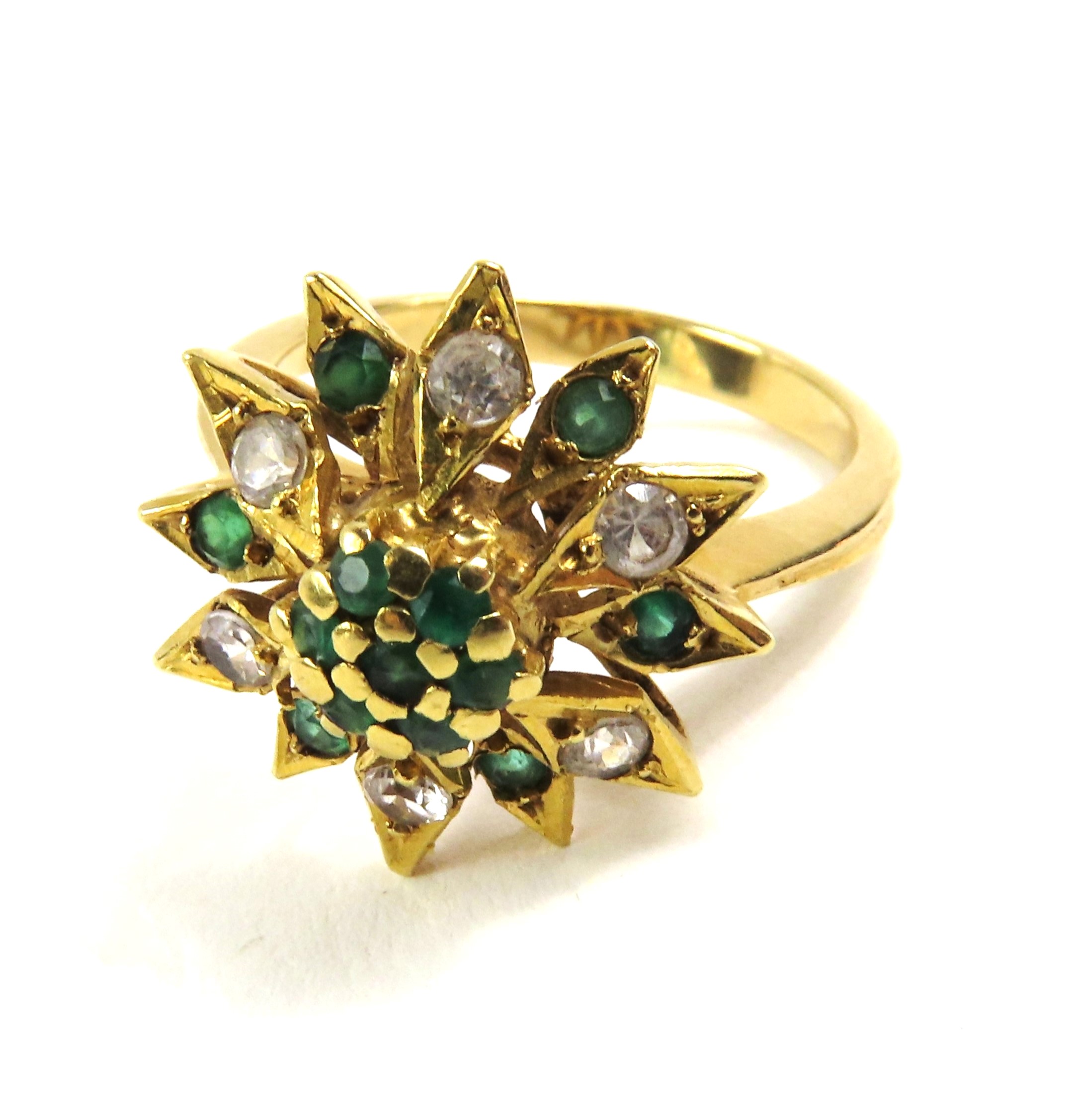 An unmarked emerald and diamond dress ring, finger