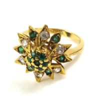 An unmarked emerald and diamond dress ring, finger