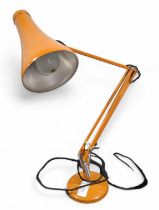 A dark orange anglepoise lamp