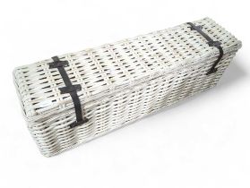 A long rectangular painted woven cane basket with