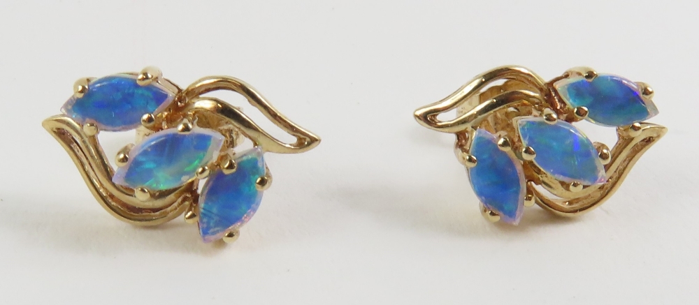 A pair of 9ct gold opal set stud earrings, the thr