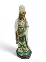 A glazed pottery figure of Guan Yin, 52cms high