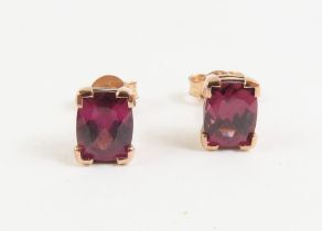 A pair of 9ct rose gold garnet set stud earrings,