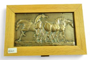A heavy brass panel cast with horses, in wood fram