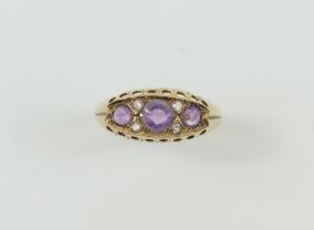 A 9ct amethyst and white stone ring, with beaded e