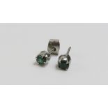 A pair of emerald single stone stud earrings, the