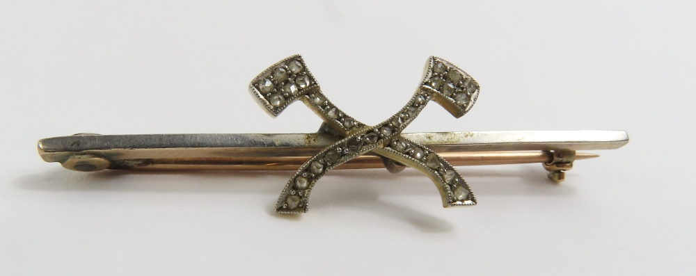 An early 20th century bar brooch set with two axe'