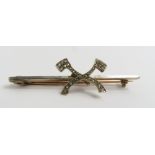 An early 20th century bar brooch set with two axe'