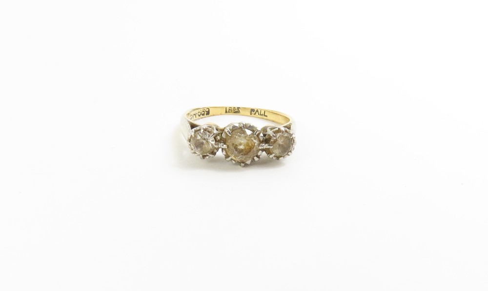 A three stone old cut diamond ring, marked '18ct',